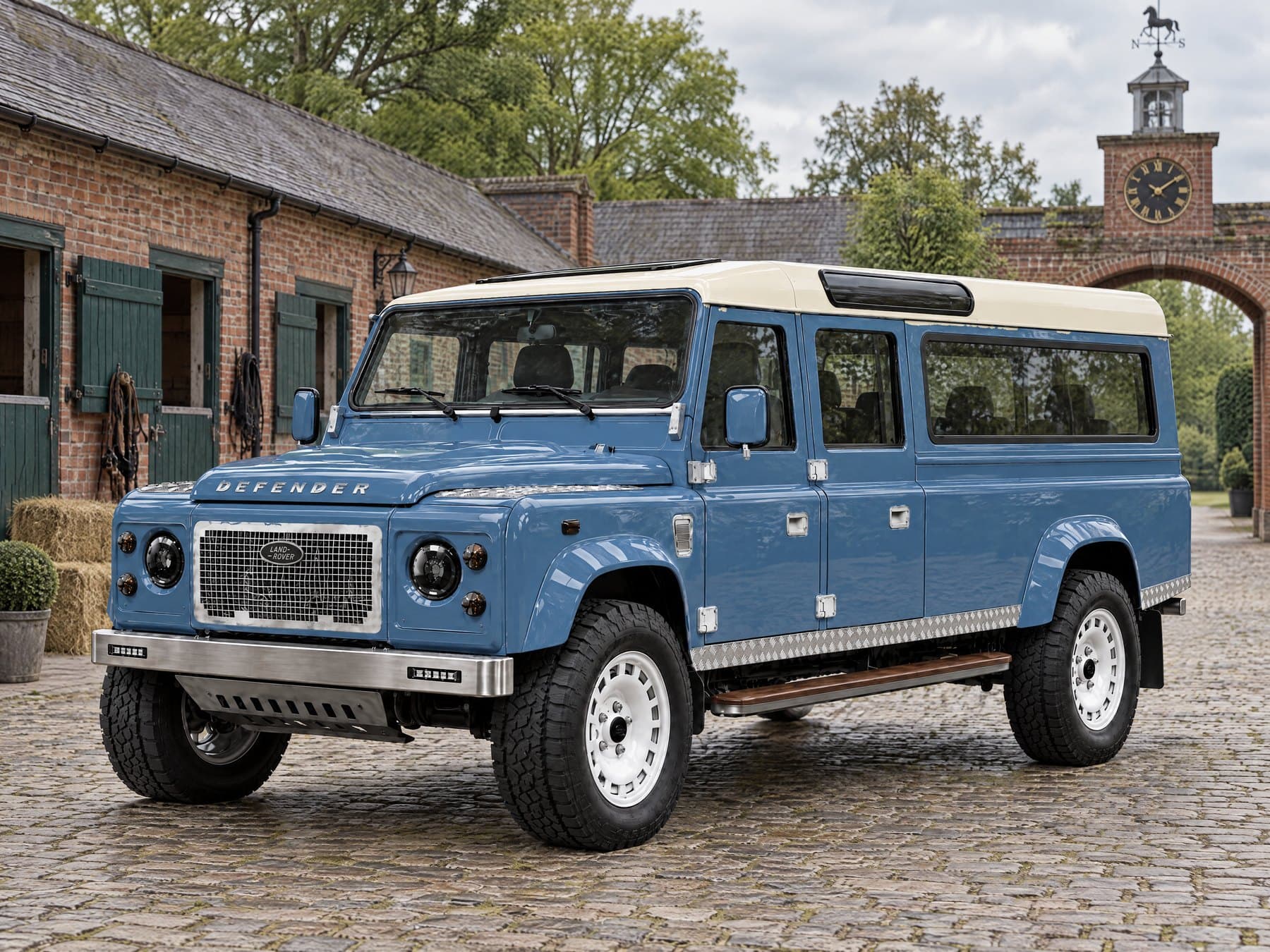 Heritage Blue Defender 130 with an ivory roof in a stable yard